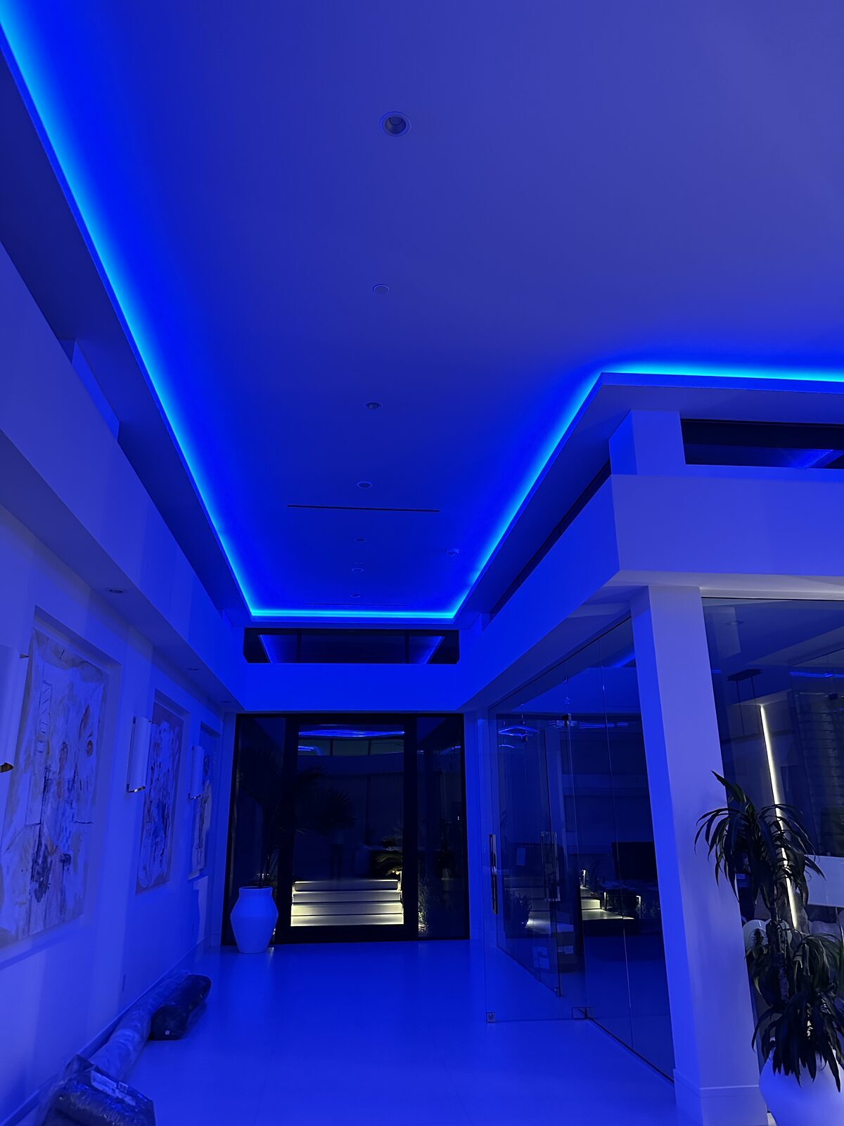 Entry hall with colour-changing cove lighting run along the ceiling perimeter
